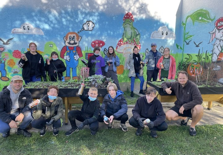 Thomas Lang (vorne links), Franjo, Oskar, Felix, Jonah, Gordon Motsch, Lilly (hinten links), Leny, Stella, Alina, Carmen Puritz, Csaba Döme und Payton verschönerten die Fassade im Schulgarten in der Schule „An den Wellenbergen“ in Bebertal.
